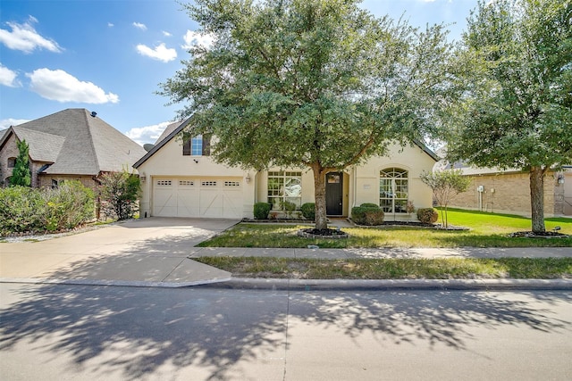 view of front of property with a garage and a front lawn