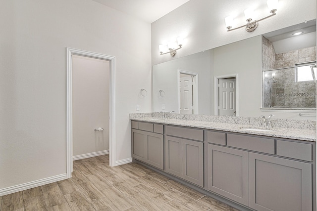 bathroom featuring vanity, an enclosed shower, and hardwood / wood-style flooring