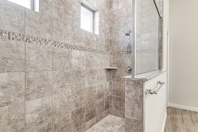 bathroom featuring a healthy amount of sunlight and tiled shower