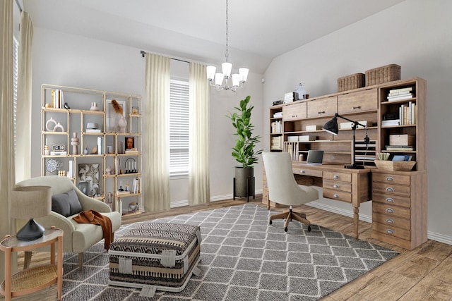 office space with vaulted ceiling and an inviting chandelier