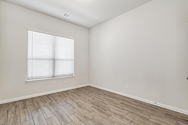 spare room featuring light hardwood / wood-style flooring