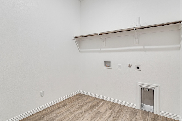 laundry area with hookup for a washing machine, light hardwood / wood-style floors, gas dryer hookup, and electric dryer hookup