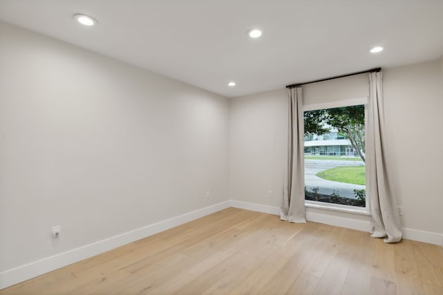 spare room featuring light hardwood / wood-style flooring