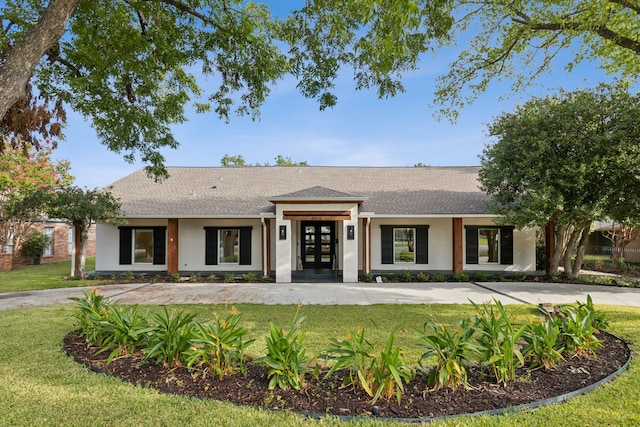 single story home featuring french doors and a front lawn