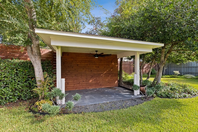 exterior space with ceiling fan and a yard