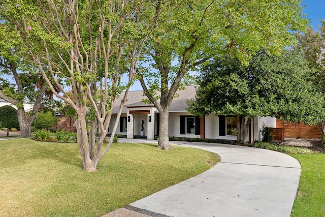 obstructed view of property with a front yard