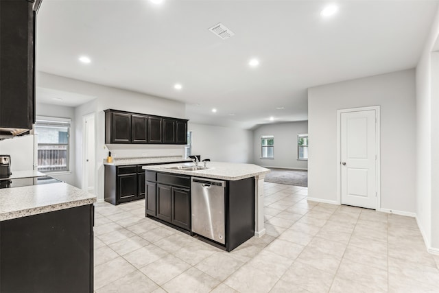 kitchen featuring a center island with sink, dishwasher, and sink