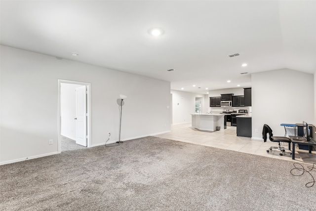 unfurnished living room featuring light carpet