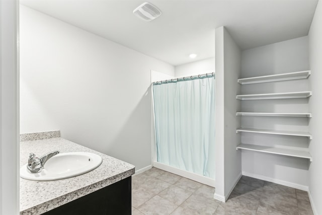 bathroom featuring vanity, tile patterned floors, and a shower with curtain