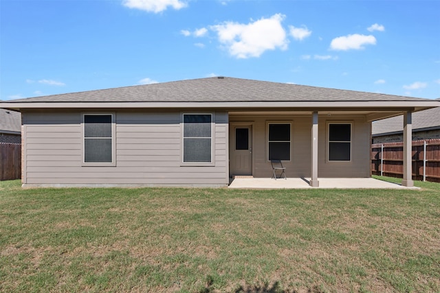 rear view of house featuring a yard