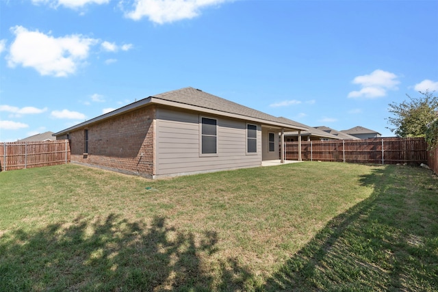 back of house with a yard