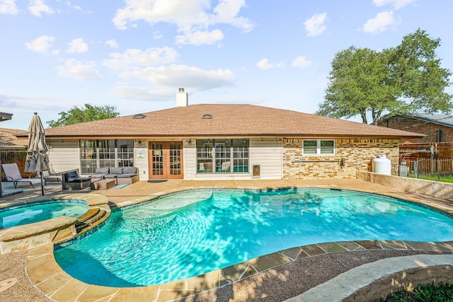 view of swimming pool featuring an outdoor living space, an in ground hot tub, and a patio area