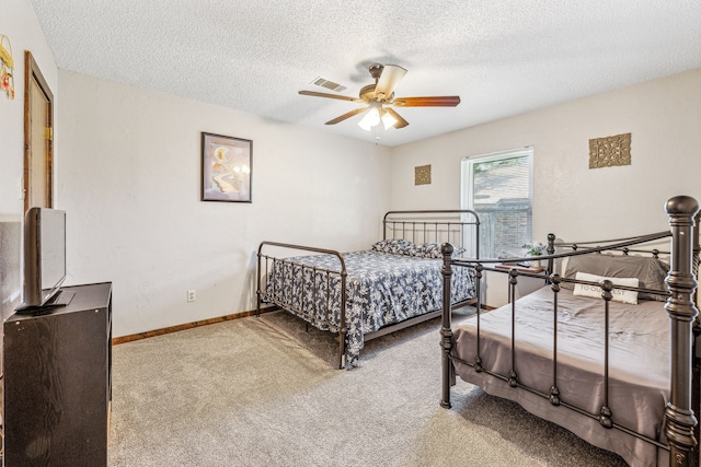 1424 Prairie Wind Blvd, Stephenville, TX 76401 - bedroom featuring carpet flooring, a textured ceiling, and ceiling fan