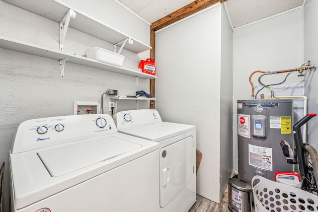 1424 Prairie Wind Blvd, Stephenville, TX 76401 - washroom with washer and dryer, electric water heater, and light wood-style floors
