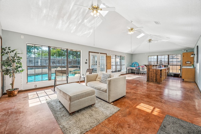 living room with a textured ceiling, vaulted ceiling, ceiling fan, and concrete flooring