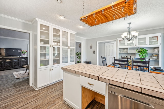 kitchen with pendant lighting, white cabinets, dishwasher, tile counters, and hardwood / wood-style floors