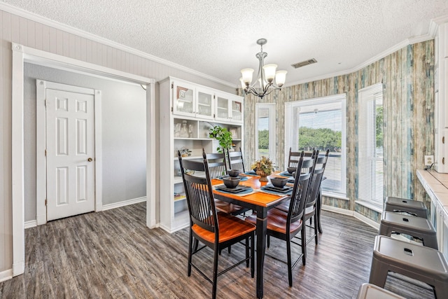 1424 Prairie Wind Blvd, Stephenville, TX 76401 - dining room with crown molding, a chandelier, dark wood-style flooring, a textured ceiling, and baseboards