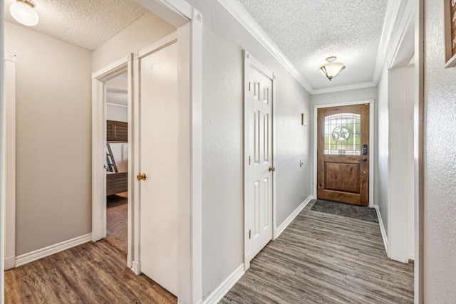 entryway featuring ornamental molding, a textured ceiling, and dark wood-type flooring