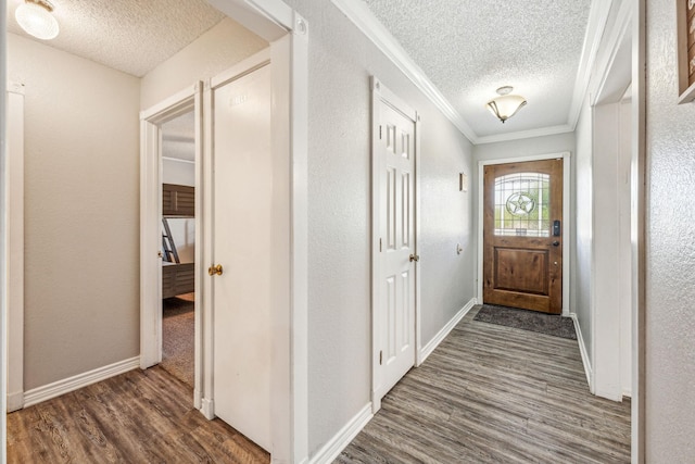 1424 Prairie Wind Blvd, Stephenville, TX 76401 - entrance foyer featuring a textured ceiling, crown molding, dark wood-style flooring, baseboards, and a textured wall