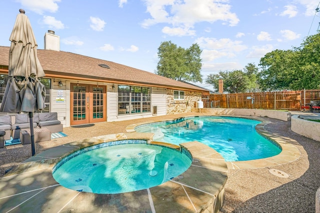 1424 Prairie Wind Blvd, Stephenville, TX 76401 - view of swimming pool featuring a patio, a fenced backyard, a pool with connected hot tub, and french doors