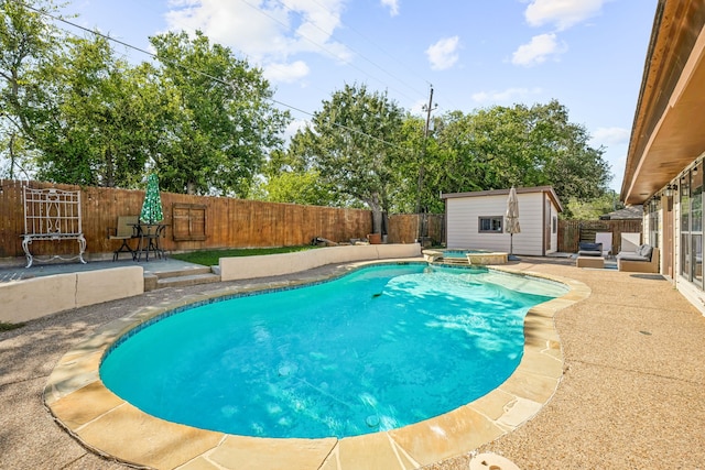 view of swimming pool featuring a shed and a patio area