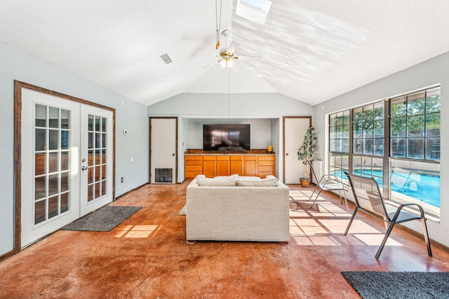 living room featuring lofted ceiling, ceiling fan, carpet floors, and french doors