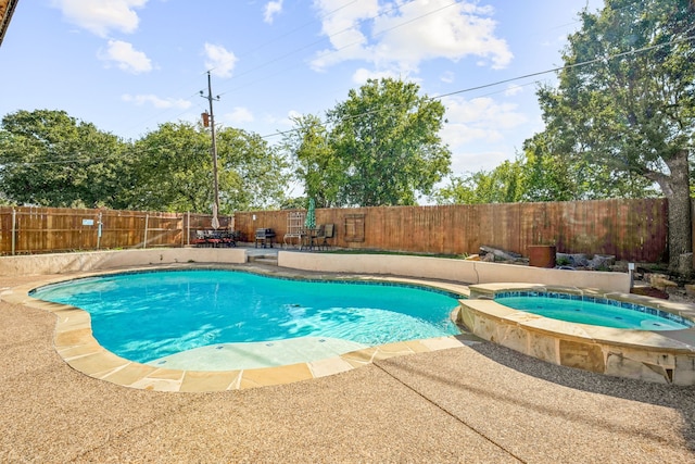 view of swimming pool with a patio and an in ground hot tub