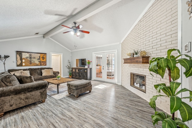 living room with a fireplace, hardwood / wood-style floors, ceiling fan, and french doors