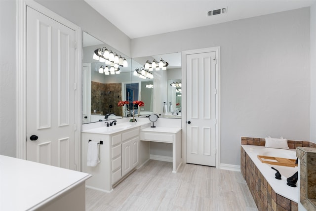 bathroom with vanity, separate shower and tub, and hardwood / wood-style flooring