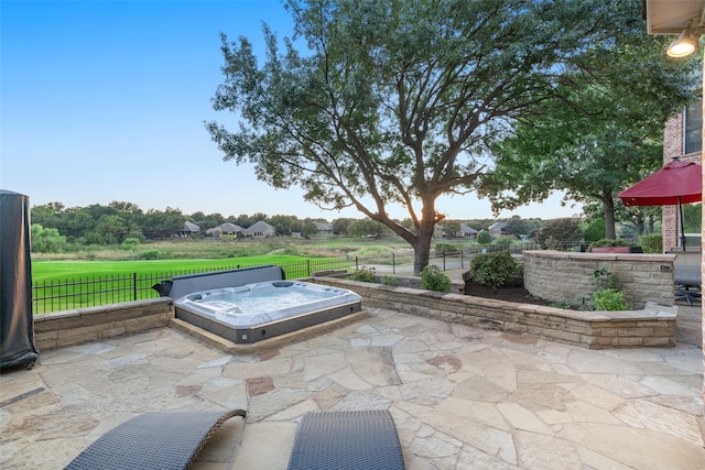 view of patio with an outdoor hot tub