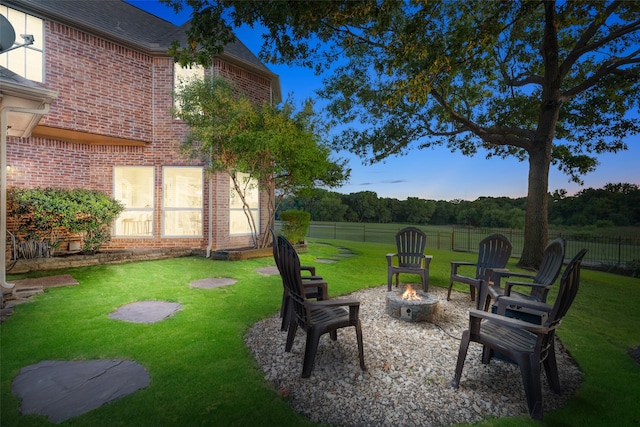 yard at dusk featuring a fire pit