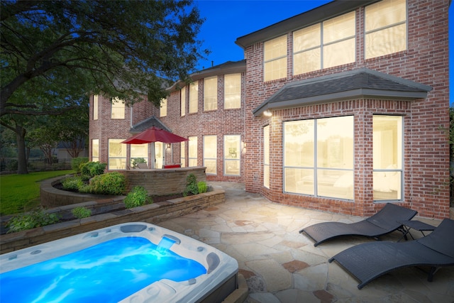 view of swimming pool featuring an outdoor hot tub and a patio area