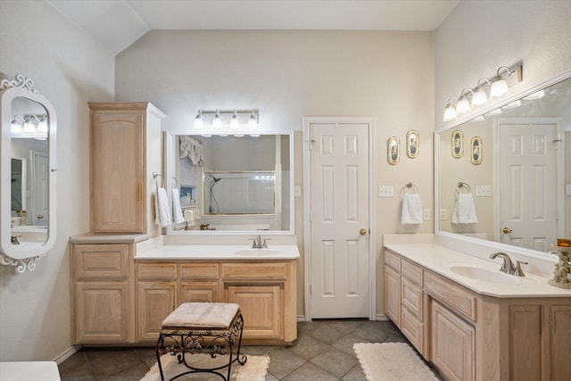 bathroom featuring tile patterned flooring, walk in shower, lofted ceiling, and vanity