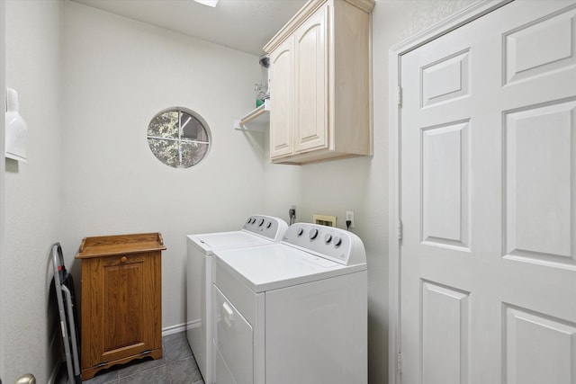 clothes washing area with light tile patterned flooring, separate washer and dryer, and cabinets