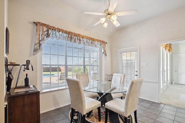 tiled dining area with vaulted ceiling and ceiling fan