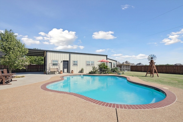 view of pool with a patio and a lawn