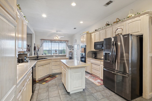 kitchen featuring ceiling fan, a center island, sink, black appliances, and light tile patterned floors