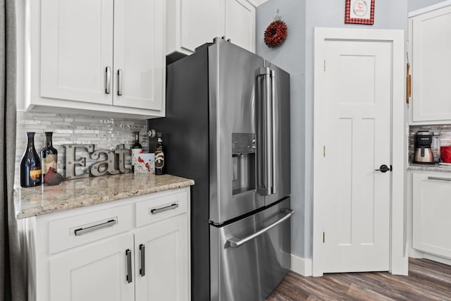 kitchen featuring stainless steel fridge, decorative backsplash, dark wood-type flooring, and white cabinets