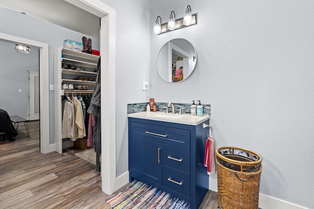 bathroom with hardwood / wood-style flooring and vanity