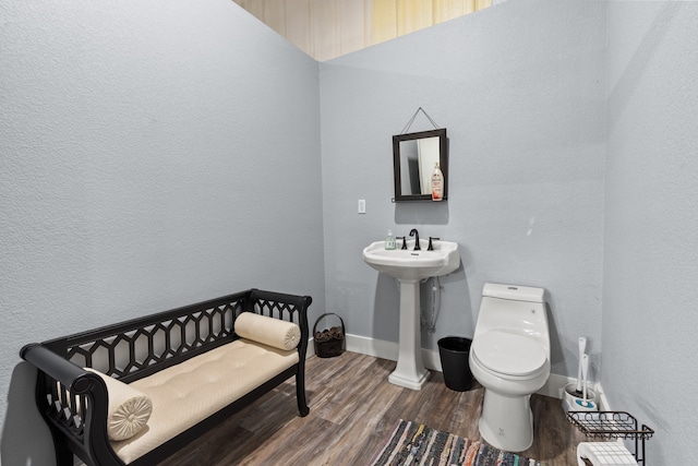 bathroom with sink, hardwood / wood-style floors, and toilet