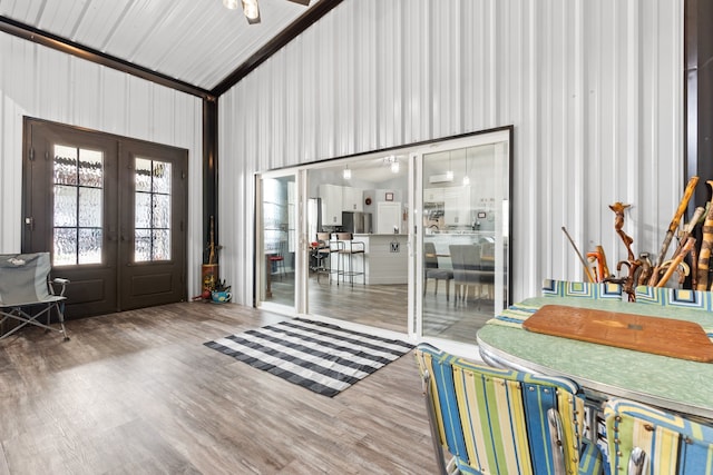 entryway with french doors, hardwood / wood-style flooring, and an inviting chandelier