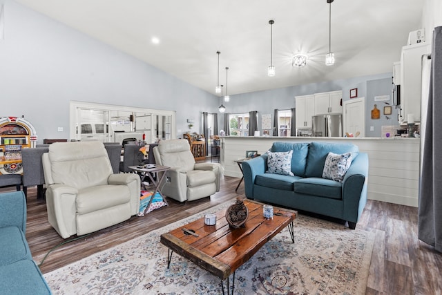 living room featuring dark hardwood / wood-style floors and high vaulted ceiling