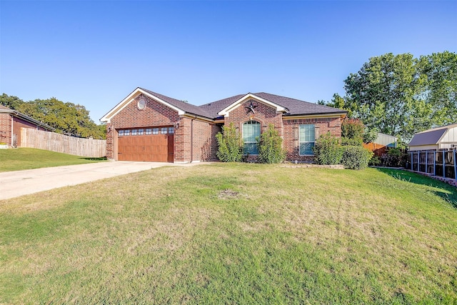 ranch-style home featuring a garage and a front lawn