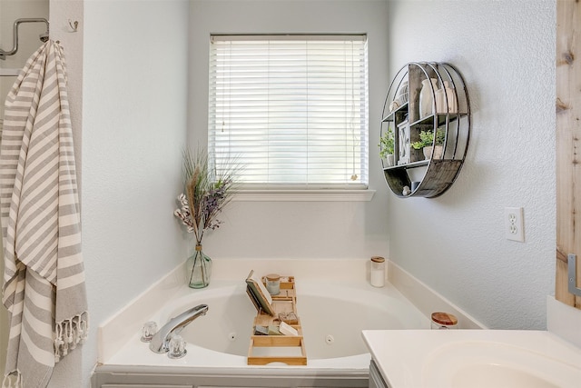 bathroom with vanity and a tub