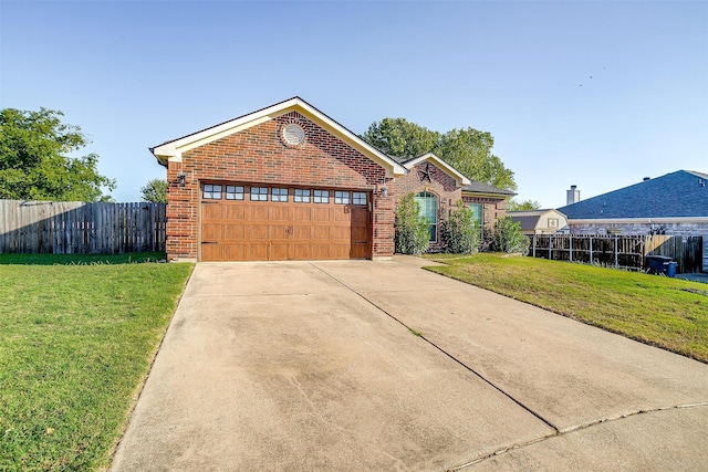 view of front of home featuring a garage and a front lawn