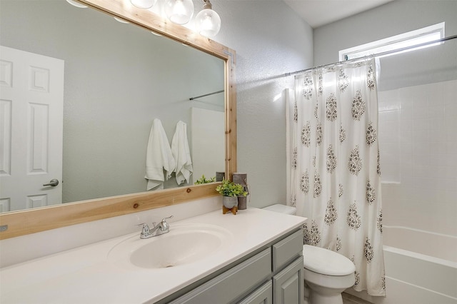 bathroom featuring vanity, shower / bath combination with curtain, and toilet