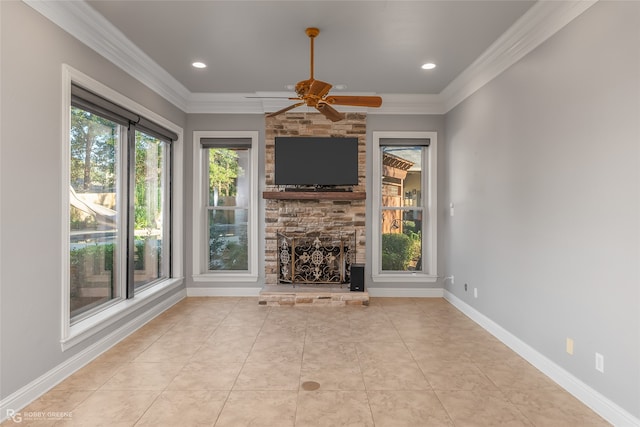 unfurnished living room featuring ceiling fan, ornamental molding, a fireplace, and light tile patterned floors