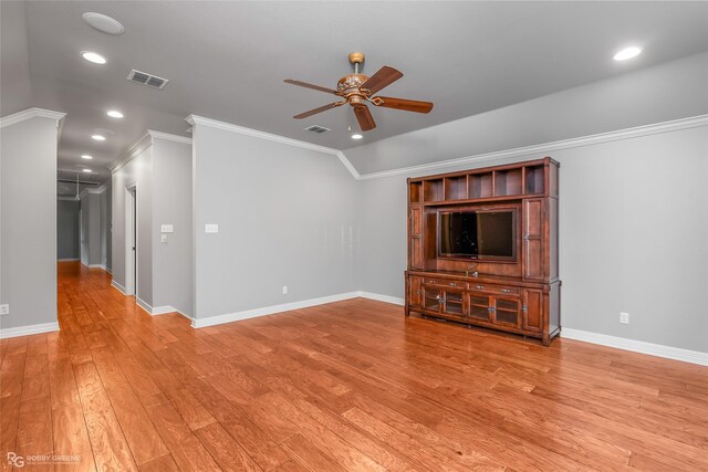 unfurnished living room with light wood-type flooring, vaulted ceiling, ceiling fan, and crown molding