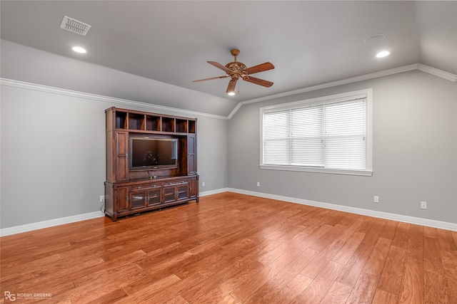 unfurnished living room with hardwood / wood-style flooring, ceiling fan, ornamental molding, and vaulted ceiling