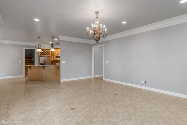 unfurnished living room with a chandelier and crown molding